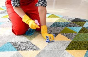 A woman removing dog urine on carpet